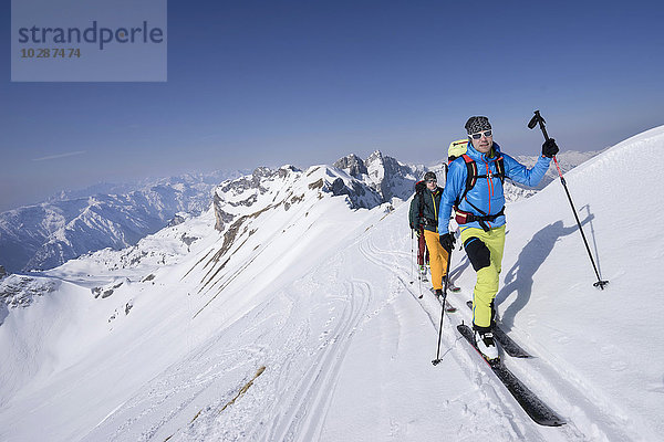 Skitourengeher beim Klettern auf einem verschneiten Berg  Tirol  Österreich