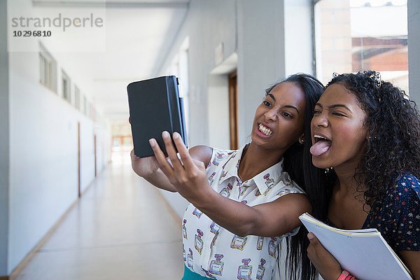 Studenten  die im Flur stehen und Selfie nehmen.