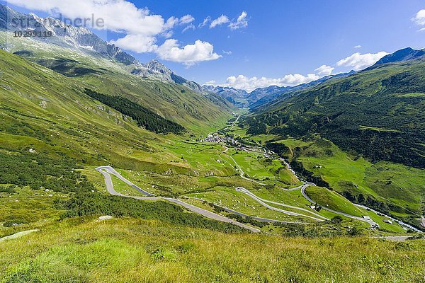 Straße zum Furkapass  Haarnadelkurven  grüne Felder am unteren Rand des Tales  Tiefenbach  Kanton Uri  Schweiz  Europa