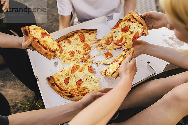 Freunde teilen sich eine Pizza