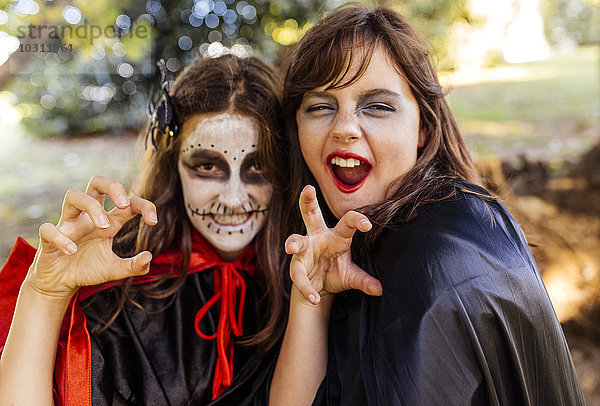 Porträt zweier maskierter Mädchen an Halloween