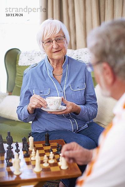 Seniorenpaar beim Schachspielen und Kaffeetrinken