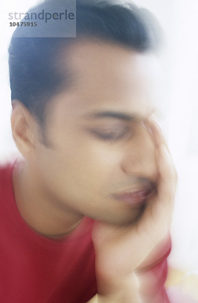 MODELL FREIGEGEBEN. Migräne. Konzeptbild eines Mannes  der unter Migräne leidet. Der Schmerz einer Migräne wird oft von Übelkeit und Sehstörungen begleitet. Migräne