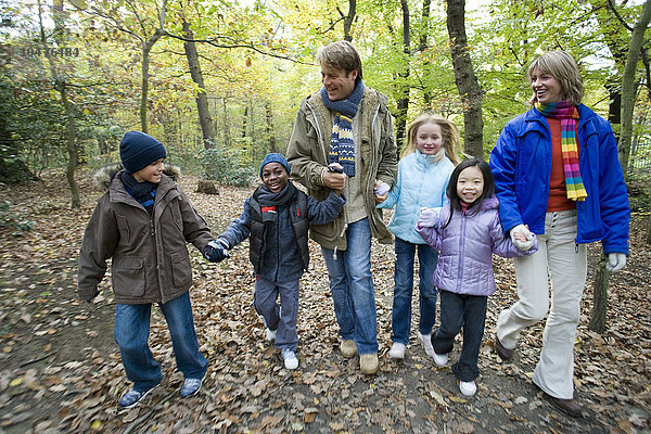 MODELL FREIGEGEBEN. Spaziergang im Wald. Eltern und Kinder gehen im Herbst in einem Wald spazieren Eltern und Kinder gehen in einem Wald spazieren
