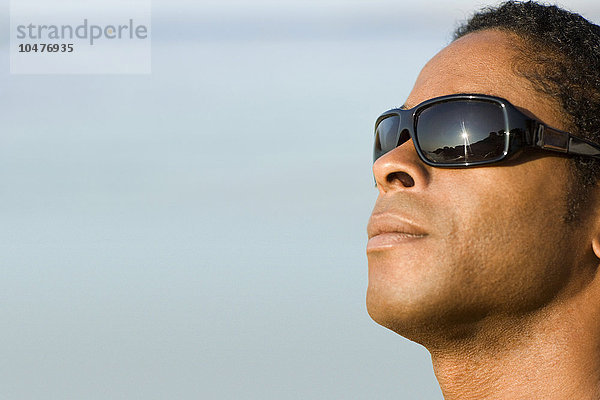 MODELL FREIGEGEBEN. Mann mit Sonnenbrille am Strand Mann mit Sonnenbrille