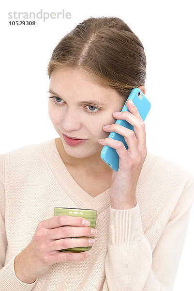 Frau mit Mobiltelefon und Tasse
