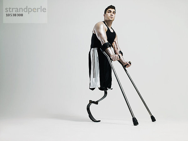 Mann mit Krücken und Beinprothese