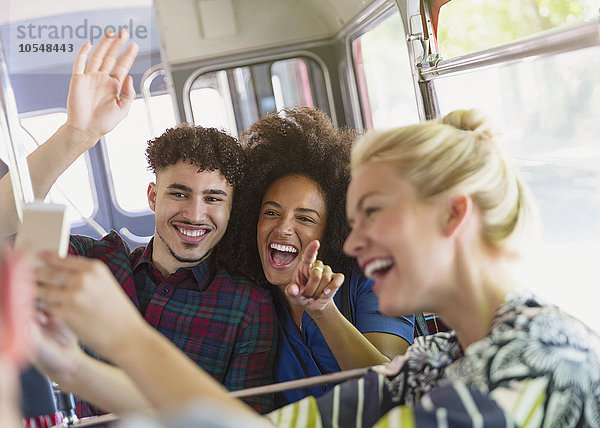 Enthusiastische Freunde nehmen Selfie mit in den Bus