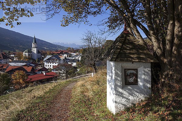 Bildstock am Weg zur Kalvarienkapelle  Herbststimmung  hinten Bad Hindelang mit der Pfarrkirche St. Johannes Baptist  Allgäu  Bayern  Deutschland  Europa