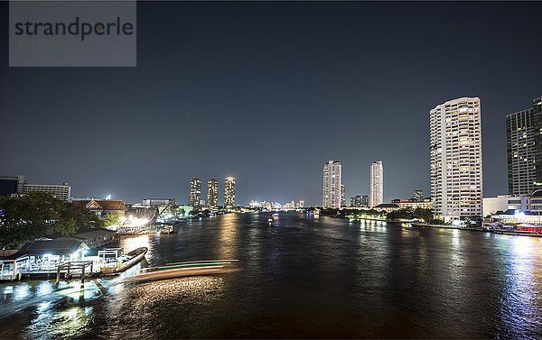 Skyline mit Booten auf dem Fluss Mae Nam Chao Phraya bei Nacht  Bangkok  Thailand  Asien