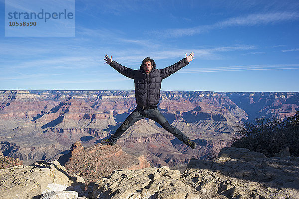 Kaukasischer Mann  der in den Grand Canyon springt  Arizona  Vereinigte Staaten