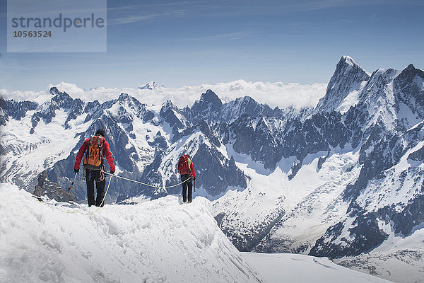 Kaukasische Skifahrer  die auf einem Berggipfel spazieren gehen  Mont Blanc  Chamonix  Frankreich
