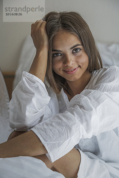 Kaukasische Frau lächelnd im Bett