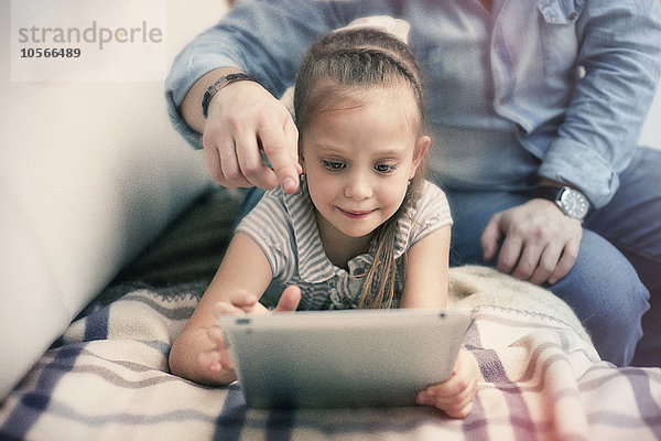 Kaukasischer Vater und Tochter benutzen ein digitales Tablet