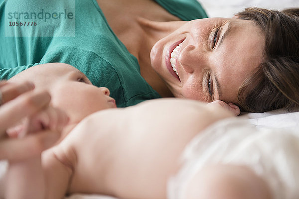 Mutter liegt mit ihrer kleinen Tochter