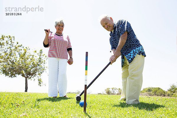 Seniorenpaar beim Krocketspiel im Freien