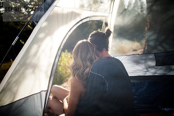 Junges Paar mit Blick aus dem sonnenbeschienenen Zelt  Lake Tahoe  Nevada  USA