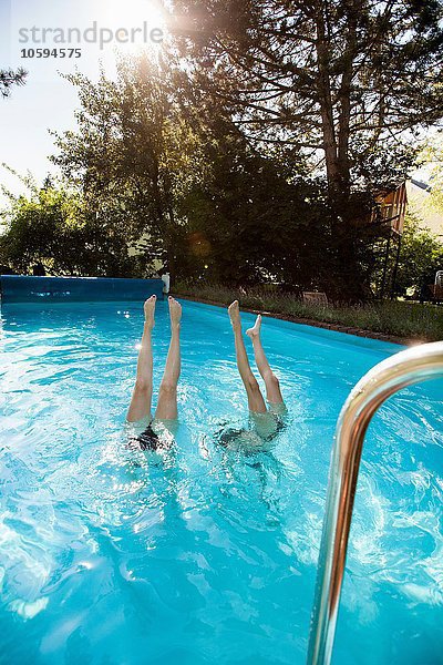 Zwei Teenager-Mädchen tauchen ins Schwimmbad.