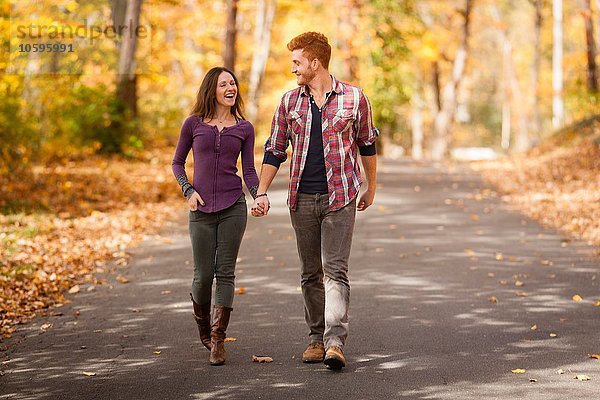 Romantisches junges Paar beim Spaziergang im Herbstwald