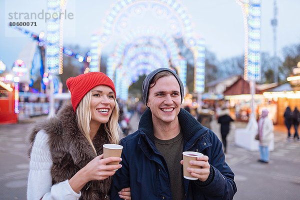 Glückliches junges Paar trinkt Glühwein beim Weihnachtsfest  Hyde Park  London  UK
