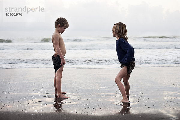 Jungen spielen zusammen am Strand