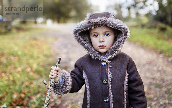 Porträt eines kleinen Mädchens mit Kapuzenjacke im Herbst