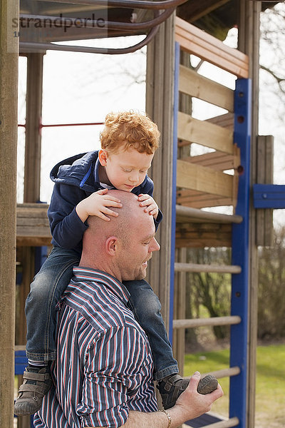 Vater mit Sohn auf dem Spielplatz