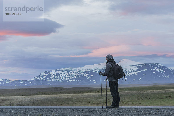 Island  Mann auf der Straße mit Blick auf Vulkane