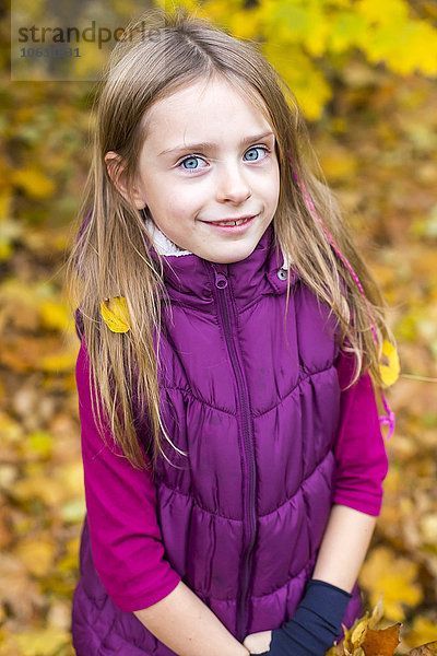 Porträt des lächelnden Mädchens im Herbst