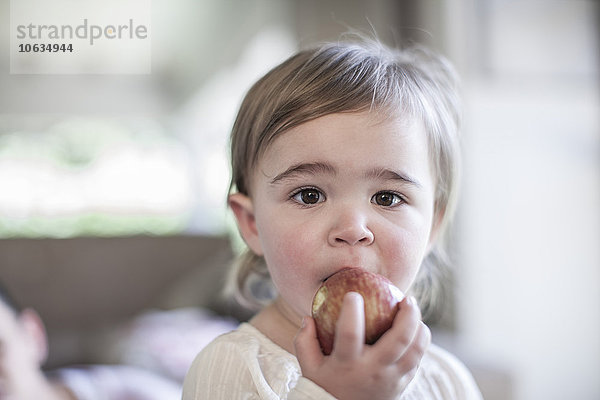Kleines Mädchen beim Essen eines Apfels