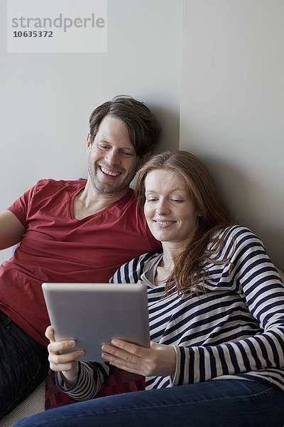 Paar mit digitalem Tablett  lächelnd