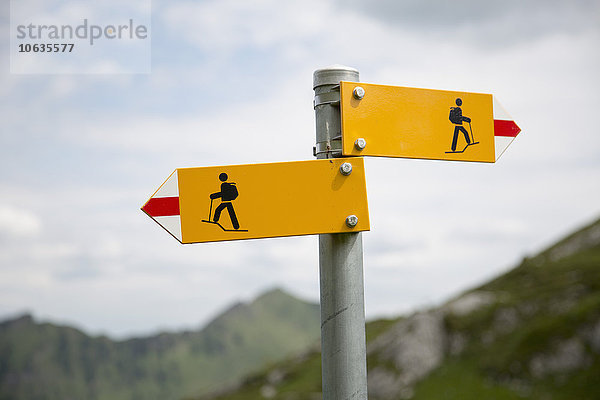 Nahaufnahme der Wanderzeichen in den Schweizer Alpen gegen den Himmel