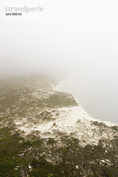 Panoramablick auf die schneebedeckte Klippe bei Nebelwetter