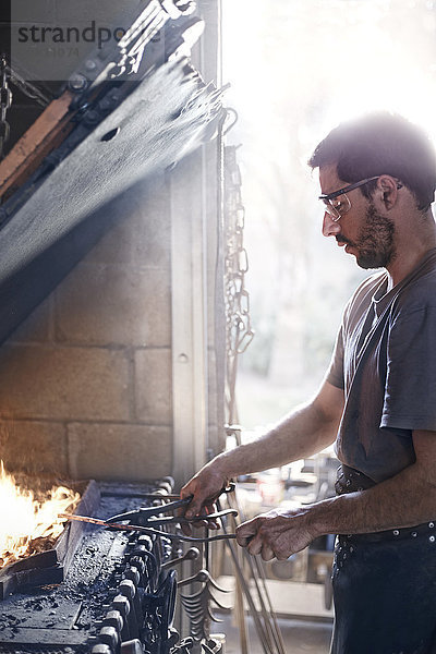 Schmiedearbeit über Feuer in der Schmiede