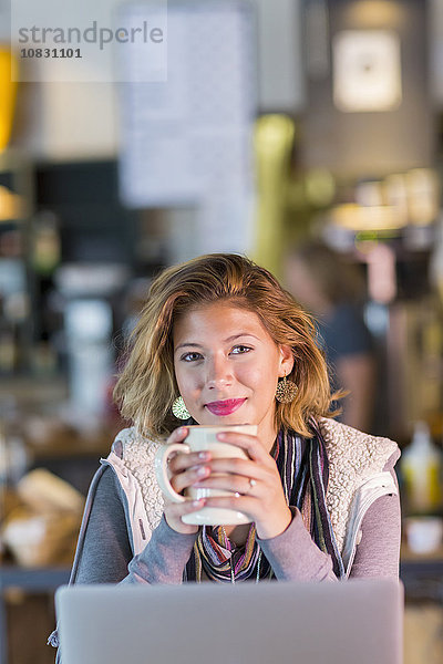 Gemischtrassiges Teenager-Mädchen trinkt eine Tasse Kaffee