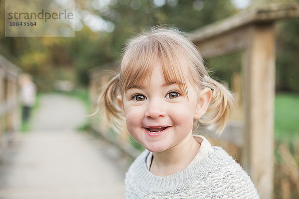 Portrait lächelndes Kleinkind Mädchen mit Zöpfen