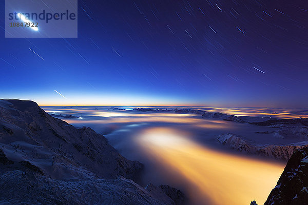 Wolkenmeer Wetterumschwung über Chamonix Tal  Sterne und Mond Lichtspuren  Chamonix  Rhone Alpes  Haute Savoie  Frankreich  Europa