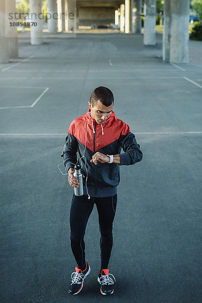 Man checking time while standing on street