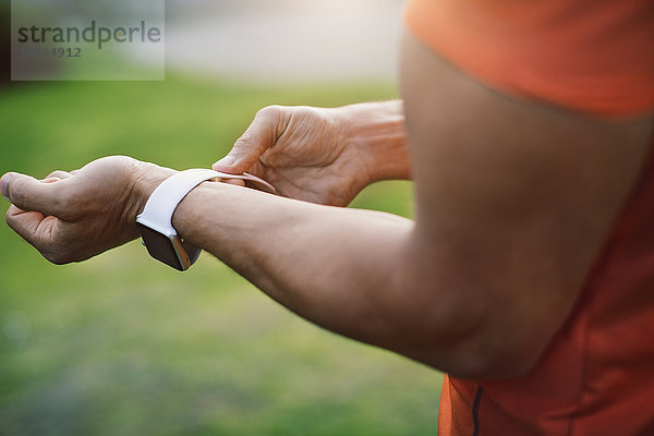 Close-up of man wearing smart watch