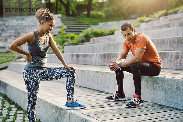 Man and woman relaxing on steps