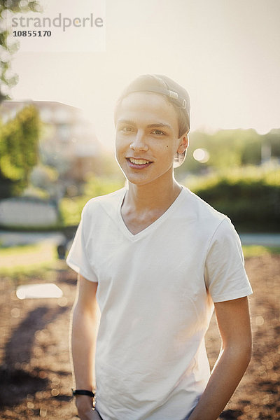 Portrait of confident male teenager standing outdoors