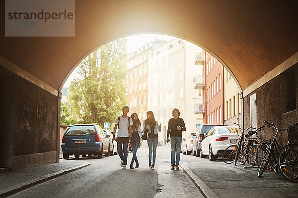 Teenagers walking in tunnel