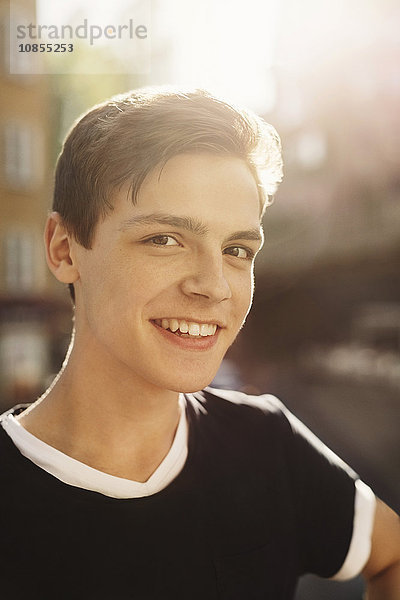 Portrait of smiling teenage boy outdoors