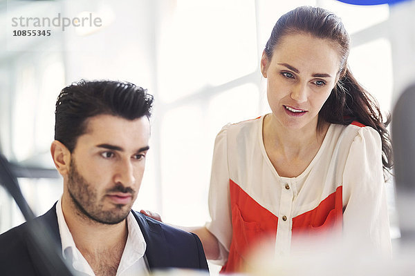 Businessman and businesswoman working together in office