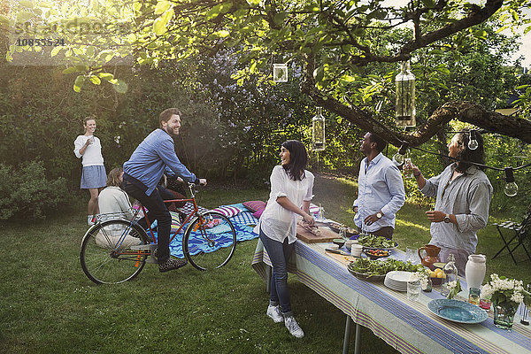 Multi-ethnic friends enjoying summer party in backyard