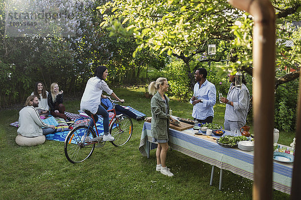 Multi-ethnic friends enjoying summer party at yard