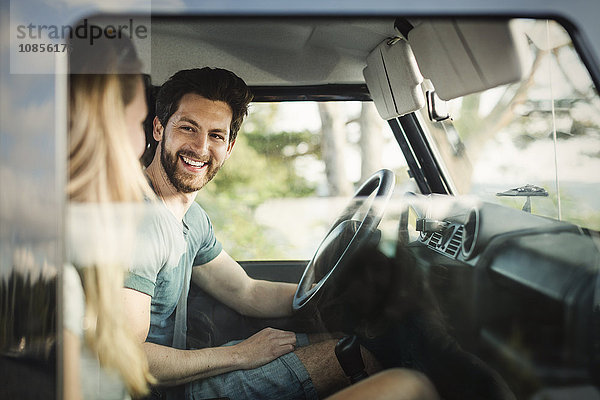 Happy man enjoying road trip with woman