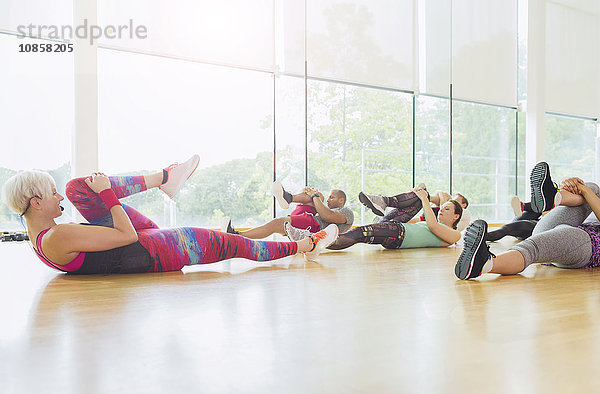 Fitnesstrainerin beim Führen der Übungsklasse Stretching Beine