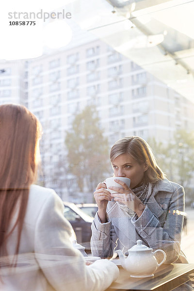 Frauen trinken Tee im Straßencafé