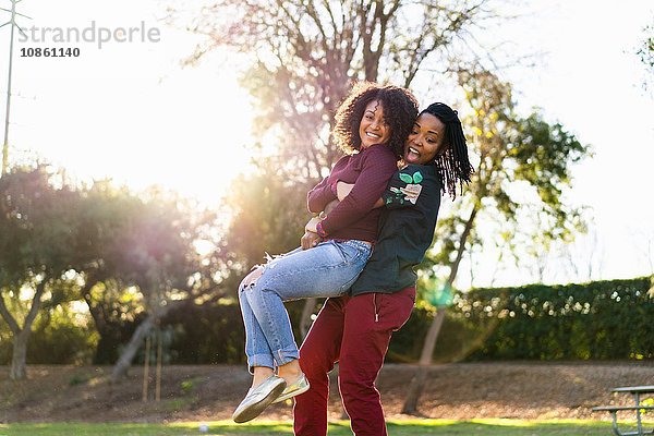 Lesbisches Paar beim Herumalbern im Park  lachend